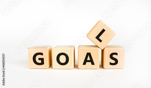 Goals symbol. The concept word 'goals' on wooden cubes on a beautiful white table. White background. Business and goals or goal concept.