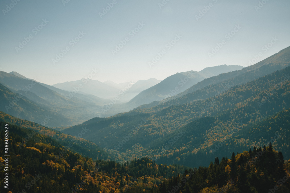 Autumn landscape in mountains overlooking cliffs with a warm day. Panoramic view of mountainous area of valley. concept is autumn travel.