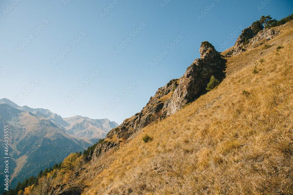 Autumn landscape in mountains overlooking cliffs with a warm day. Diagonal composition. concept is autumn travel.
