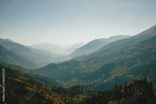Autumn landscape in mountains overlooking cliffs with a warm day. Panoramic view of mountainous area of valley. concept is autumn travel.