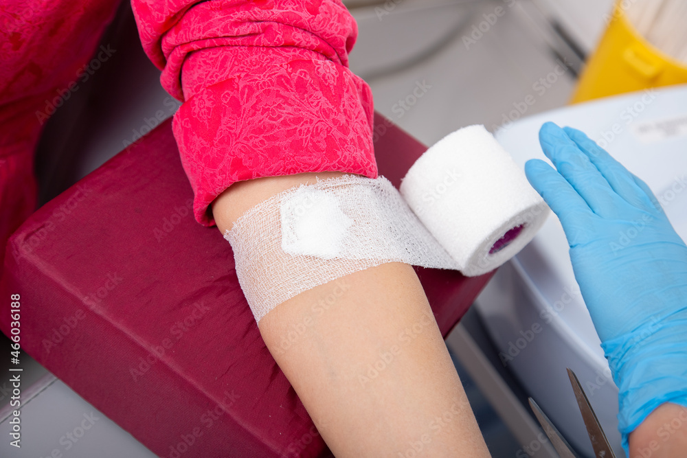 laboratory assistant draws blood from a patient's vein with a disposable syringe. concept is test for covid-19 in medical institution. laboratory assistant draws blood from a patient's vein with a disposable syringe. concept is test for covid-19 in medical institution.