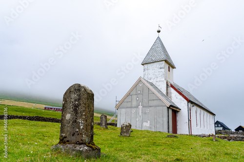 Beautiful Church in the village of Videreidi in the Fareo islands, covered in mist  photo