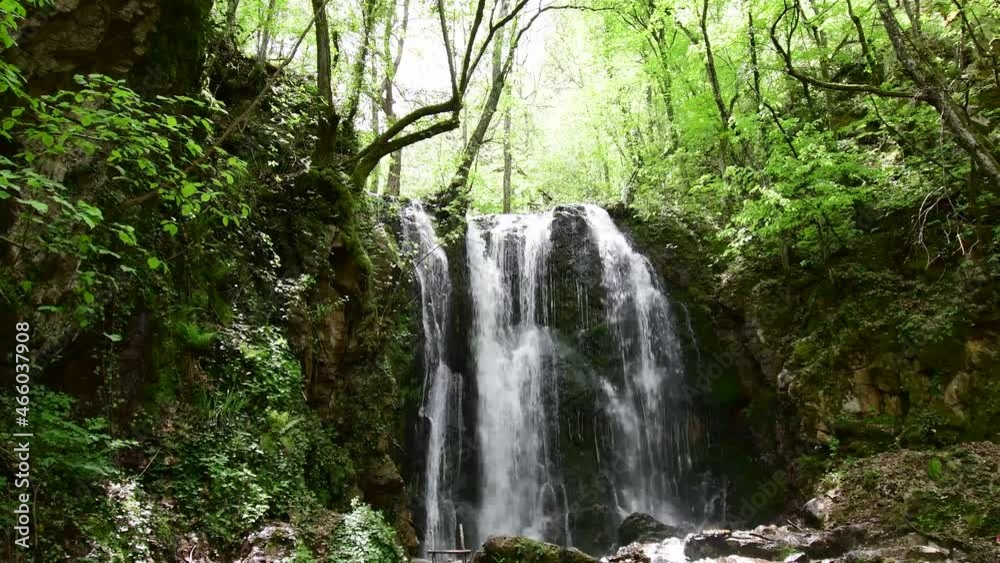 A beautiful waterfall falls down the mountain A beautiful waterfall falls down the mountain