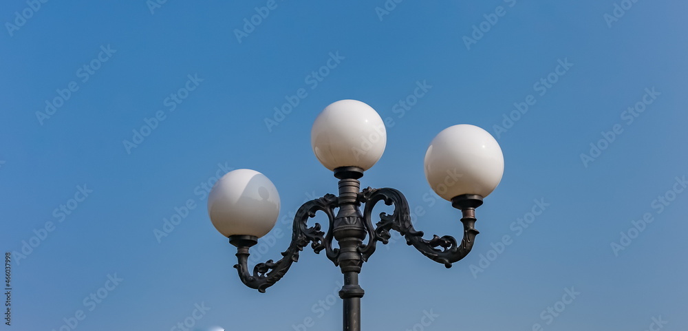 Street lamp close-up against the blue sky in summer Street lamp close-up against the blue sky in summer