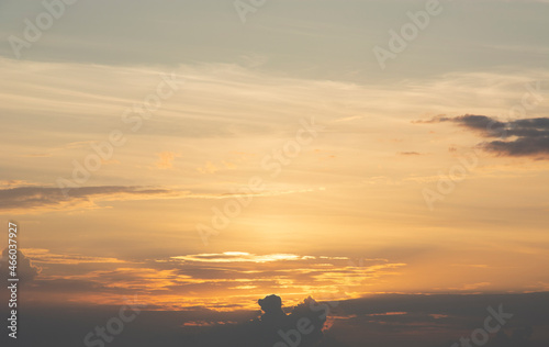 evening sunset the rays of the setting sun paint the sky in different colors with white, gray and orange clouds. © Dmitry