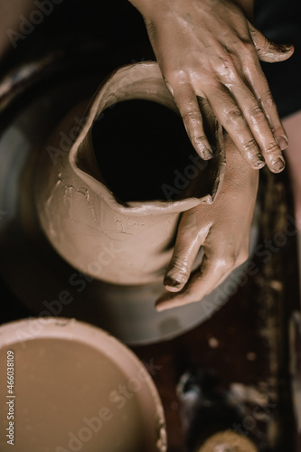 young girl in a white shirt makes a pitcher of clay on a potter s wheel. Pottery workshop of a creative woman. Concept - hobby clay modeling