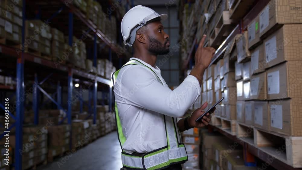Business concept of 4k Resolution. An employee is checking the goods with a tablet in the warehouse. Business concept of 4k Resolution. An employee is checking the goods with a tablet in the warehouse.