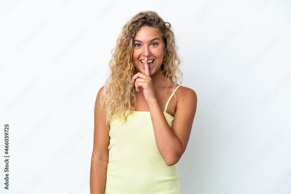 Girl with curly hair isolated on white background showing a sign of silence gesture putting finger in mouth Girl with curly hair isolated on white background showing a sign of silence gesture putting finger in mouth