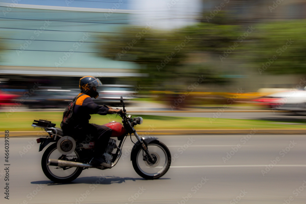 Motorcyclist going fast in the city