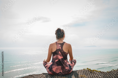 Yoga on the beach. Girl doing yoga with a view. photo