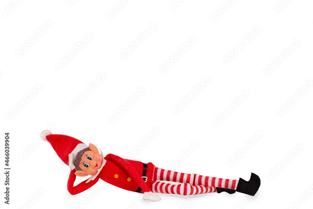Christmas Elf toy on an isolated white background with copy space. Christmas spirit, Christmas shelf tradition. - obrazy, fototapety, plakaty 