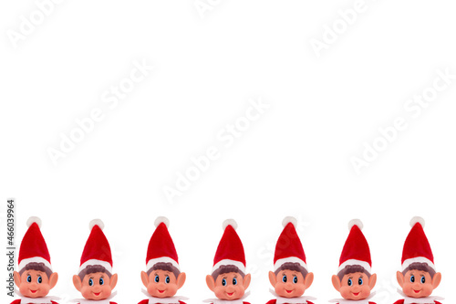 Christmas Elf toy peeking heads on an isolated white background with copy space. Christmas spirit, Christmas shelf tradition.