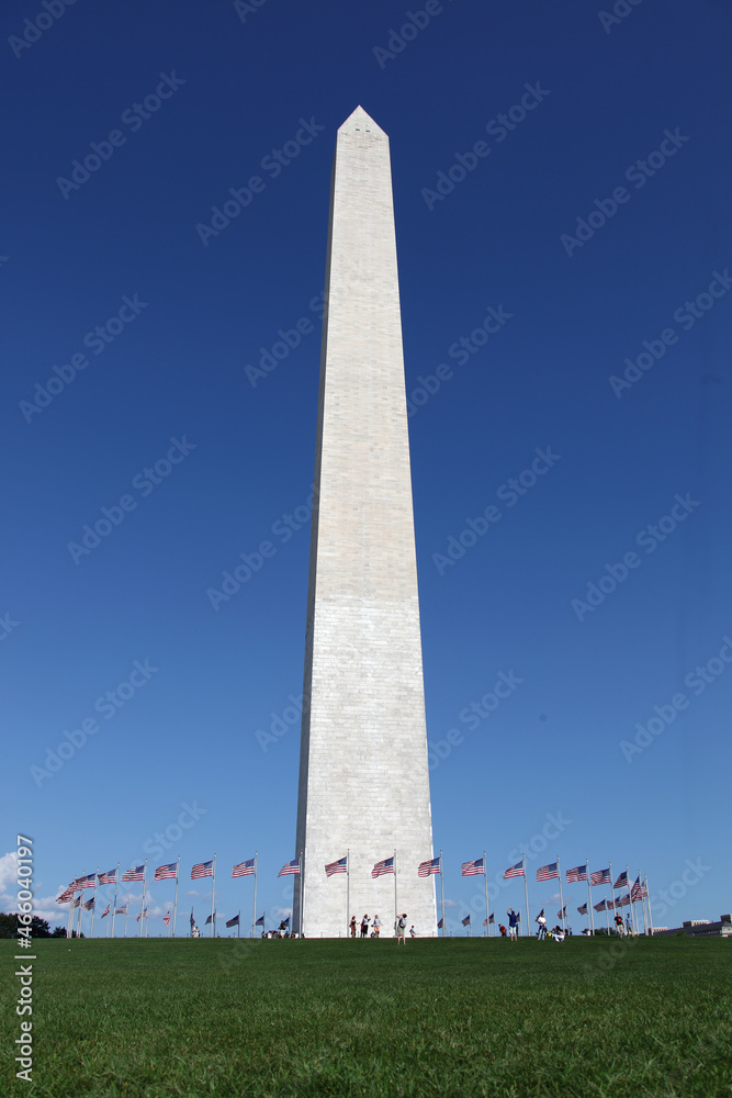 Washington Memorial showing circle of flags in blue sky