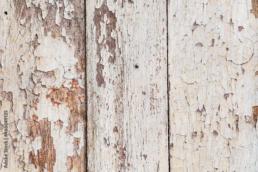 Peeling white paint on old wooden boards. Peeling white paint on old wooden boards.