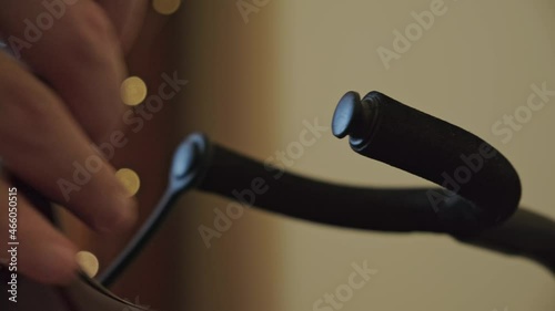 Man picking up the acoustic guitar from the stand close up.