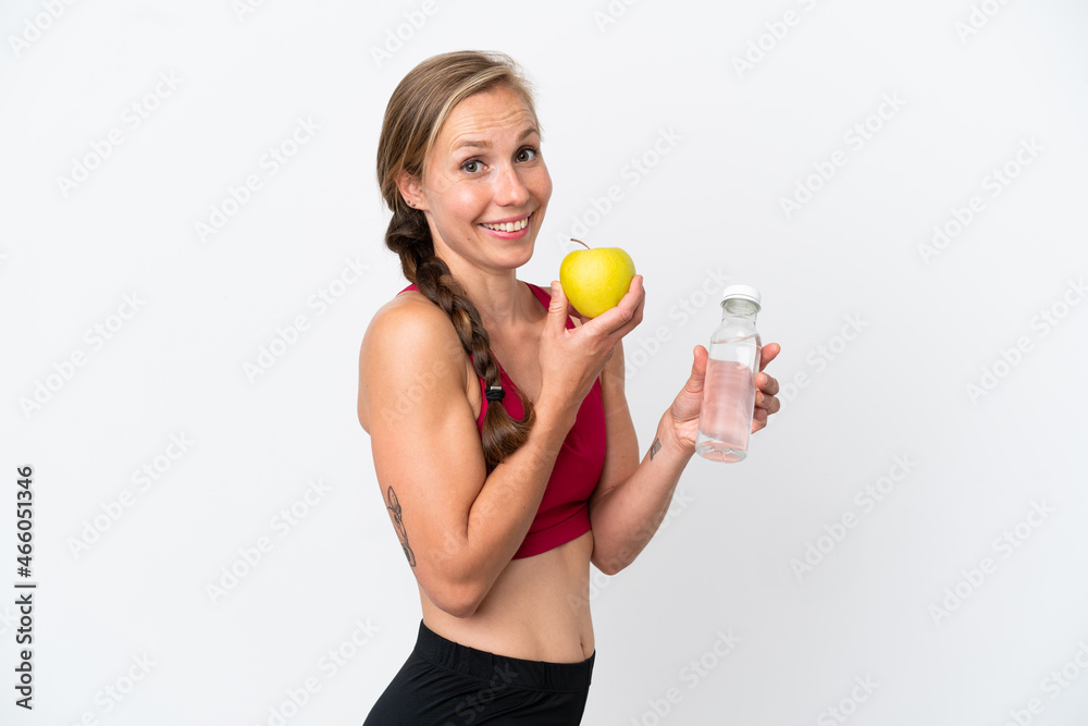 Young English woman isolated on white background with an apple and with a bottle of water Young English woman isolated on white background with an apple and with a bottle of water