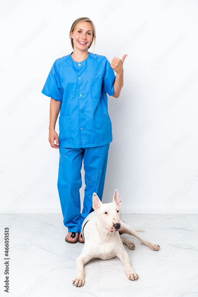 Young veterinarian English woman with dog isolated on white background