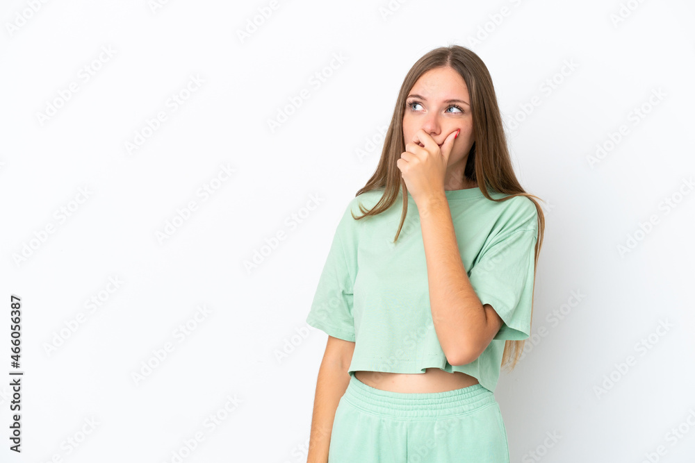 Young Lithuanian woman isolated on white background having doubts and with confuse face expression Young Lithuanian woman isolated on white background having doubts and with confuse face expression