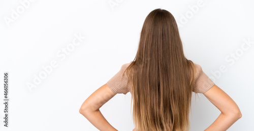 Young Lithuanian woman isolated on white background in back position