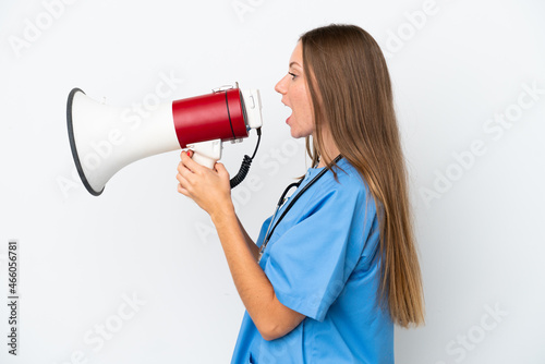 Young surgeon doctor Lithuanian woman isolated on white background shouting through a megaphone