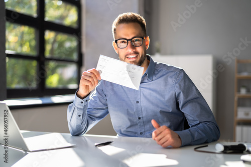 Holding Paycheck Or Payroll Check Or Insurance Cheque photo