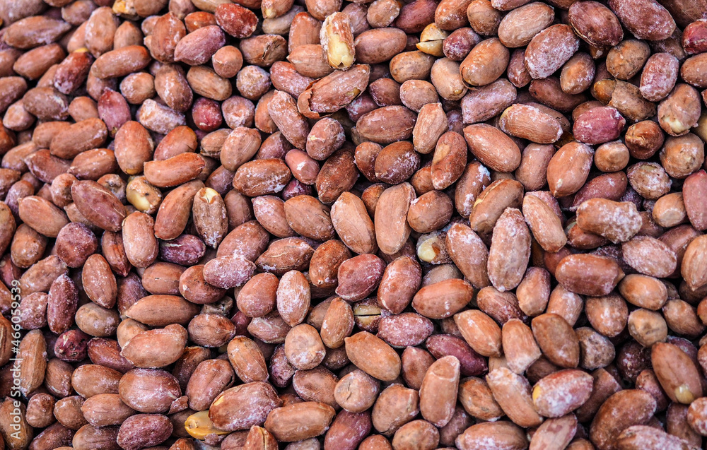 Pile of dry roasted peanuts displayed on street market, closeup detail from above Pile of dry roasted peanuts displayed on street market, closeup detail from above