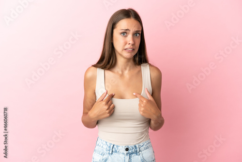 Young woman over isolated pink background pointing to oneself © luismolinero