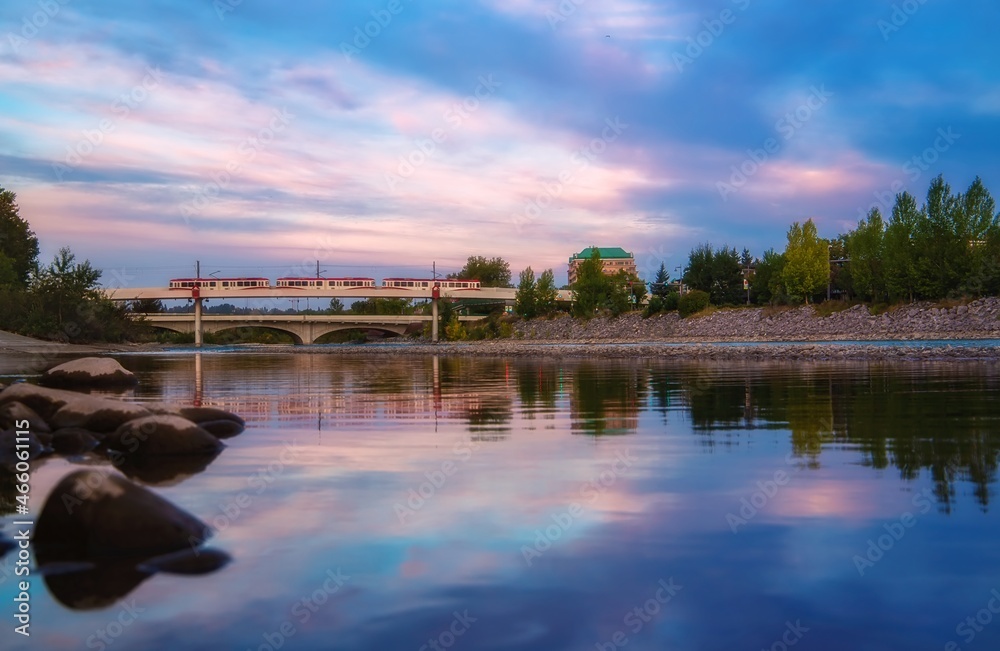 City Train Crossing The Bow River At Sunrise