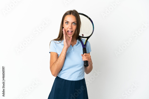 Woman playing tennis over isolated white wall with surprise and shocked facial expression © luismolinero