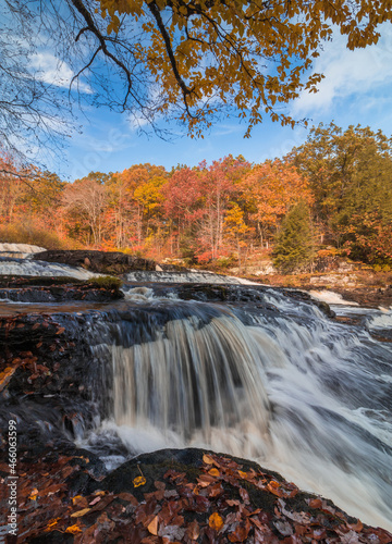 Shohola Falls in the Pennsylvania Poconos on a beautiful fall morning surrounded by peak fall foliage. Waterfalls in the fall.