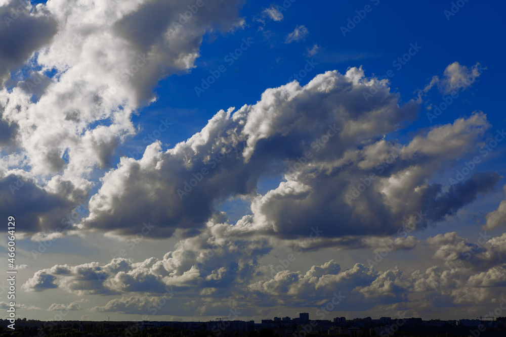 Cumulus clouds over the city . Daytime cloudscape Cumulus clouds over the city . Daytime cloudscape