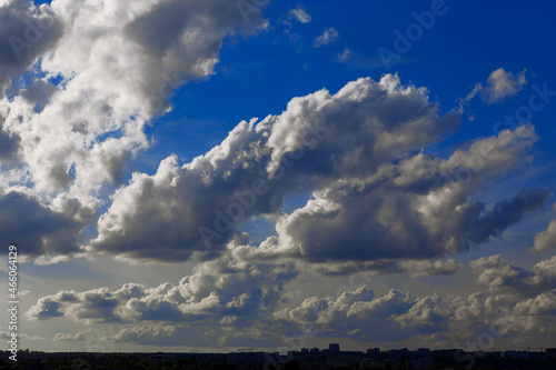 Cumulus clouds over the city . Daytime cloudscape 