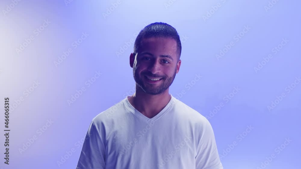 Professional football player portrait. Sportsman trainer smiling close-up, posng on blue background in studio. Sports school concept. Young man winner looking in camera. Professional football player portrait. Sportsman trainer smiling close-up, posng on blue background in studio. Sports school concept. Young man winner looking in camera.