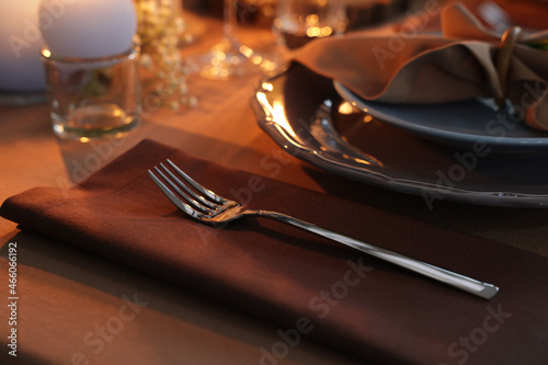 Beautiful setting with cutlery and plates on table