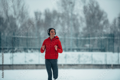 Woman running and training on a cold winter day