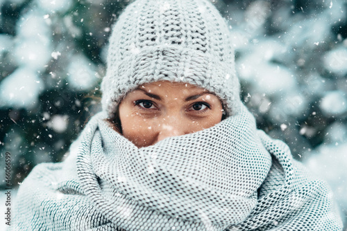 Beautiful young woman wearing scarf and a a hat on a cold winter day