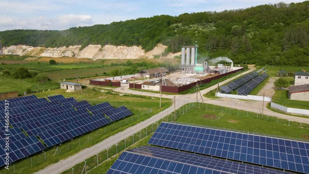 Aerial view of electrical power plant with rows of solar photovoltaic panels for producing clean ecological electric energy at industrial area. Renewable electricity with zero emission concept Aerial view of electrical power plant with rows of solar photovoltaic panels for producing clean ecological electric energy at industrial area. Renewable electricity with zero emission concept