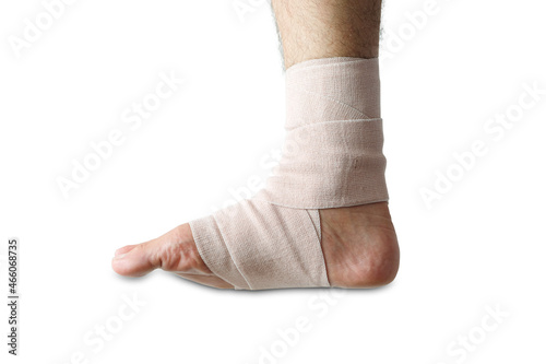 Young athlete's leg has ankle pain and Elastic Bandage is attached to the ankle. Concept of health.