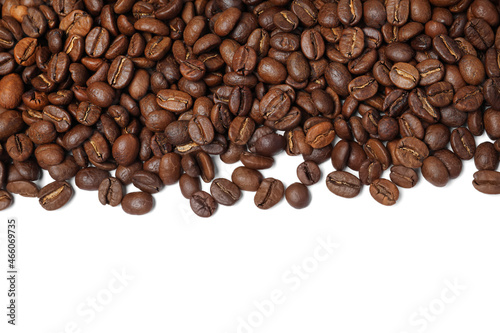Many roasted coffee beans on white background, top view