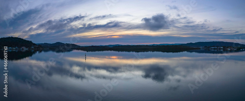 Sunrise panorama over the bay with cloud reflections