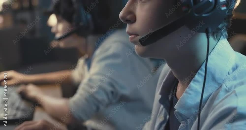 Teenagers playing video games together Teenagers playing video games together