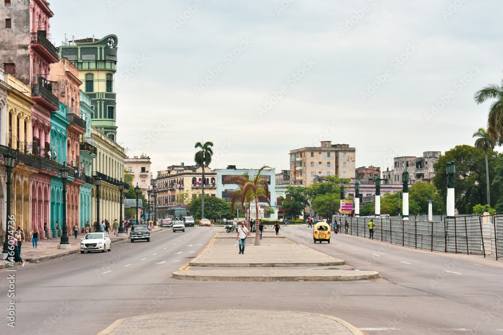 HAVANA, CUBA - AUGUST 26, 2017: Street scene with cocotaxi and colorful buildings in Old Havana, Cuba
