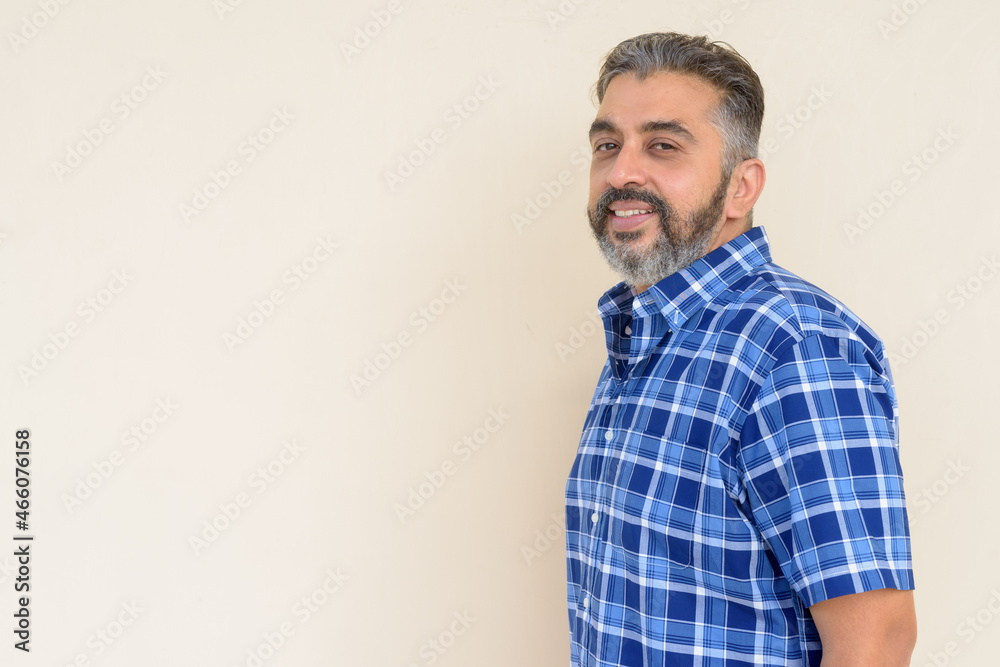 Portrait of bearded Indian businessman against plain background Portrait of bearded Indian businessman against plain background