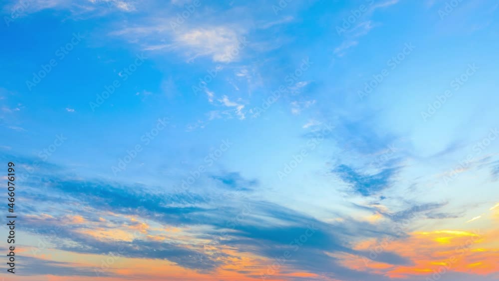 Colorful clouds are changing shapes on the blue sky at sunset.Sky sunset clouds time lapse.