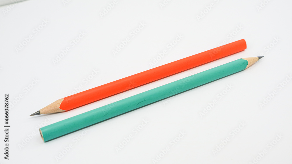 Pencils placed on white paper background with copy space for your image or text. Pencils placed on white paper background with copy space for your image or text.