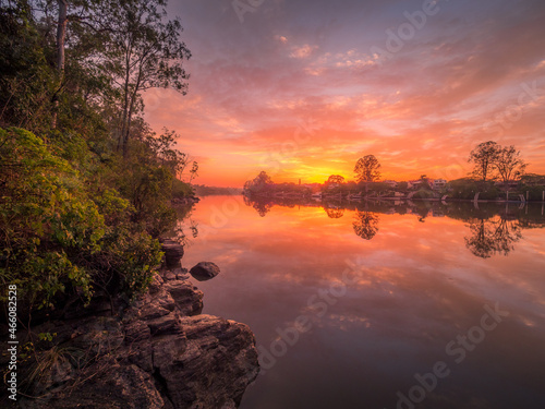 Beautiful Riverside Sunrise with Cloud Reflections © Kevin