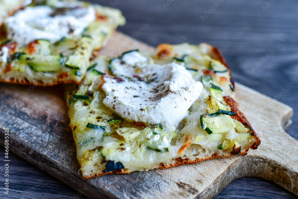 Italian Focaccia with zucchini and ricotta cheese with crispy crust . Full 72 hour pizza dough fermentation method. Roman style pizza slice Italian Focaccia with zucchini and ricotta cheese with crispy crust . Full 72 hour pizza dough fermentation method. Roman style pizza slice