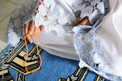 Moslem women holding prayer beads when praying photo