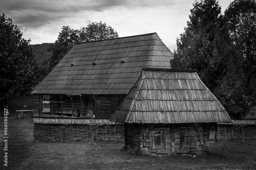 photo of an old farm house and a chicken cottage in black and white. photo of an old farm house and a chicken cottage in black and white.