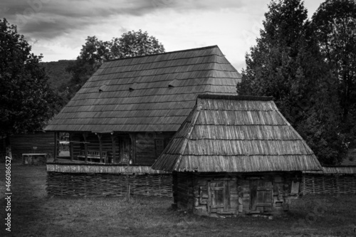 photo of an old farm house and a chicken cottage in black and white.